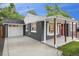Charming home featuring a gray brick exterior, white trim, and a bright red front door at 5515 Dudley Ct, Arvada, CO 80002