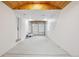 Clean garage with a wood plank ceiling, white walls, and overhead storage at 5515 Dudley Ct, Arvada, CO 80002