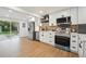 Modern kitchen with stainless steel appliances, white cabinets, and sleek countertops at 5515 Dudley Ct, Arvada, CO 80002