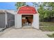 Backyard shed provides extra outdoor storage on a concrete pad with open doors at 5515 Dudley Ct, Arvada, CO 80002
