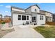 Backyard features a well-maintained lawn, patio, grill, and exterior of the house, ready for entertaining at 3980 Trail Stone Cir, Castle Rock, CO 80108