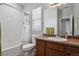 This full bathroom features a shower-tub combo, a neutral color palette, and great natural light at 3980 Trail Stone Cir, Castle Rock, CO 80108