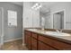 The full bathroom includes a double vanity, a shower with a glass door and a window at 3980 Trail Stone Cir, Castle Rock, CO 80108