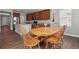 Charming dining area with a wooden table, hardwood floors, ample natural light, and seamless flow to kitchen at 3980 Trail Stone Cir, Castle Rock, CO 80108