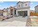 Two-story home with a concrete driveway leading to a two-car garage and stone entryway at 3980 Trail Stone Cir, Castle Rock, CO 80108