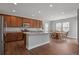 Modern kitchen with stainless steel appliances, granite countertops, center island and view to dining room at 3980 Trail Stone Cir, Castle Rock, CO 80108