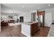 Bright kitchen with a view to the living room featuring stainless steel appliances, granite countertops, and stylish finishes at 3980 Trail Stone Cir, Castle Rock, CO 80108