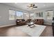 Bright living room with hardwood floors, stylish furnishings, and large windows offering plenty of natural light at 3980 Trail Stone Cir, Castle Rock, CO 80108
