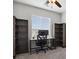 This home office has a ceiling fan, built in shelves, and a dedicated workspace at 3980 Trail Stone Cir, Castle Rock, CO 80108