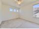Bright, empty bedroom with neutral carpeting and large windows offering plenty of natural light at 10904 Eagle Run Dr, Parker, CO 80138