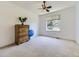 Bright bedroom features a neutral color palette, ceiling fan, and a large window offering natural light at 10904 Eagle Run Dr, Parker, CO 80138