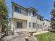 Exterior view of the home showcasing the spacious backyard and large windows that bring in natural light at 10904 Eagle Run Dr, Parker, CO 80138