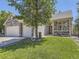 Inviting home with a well-manicured lawn and covered porch, complemented by stone and siding accents at 10904 Eagle Run Dr, Parker, CO 80138