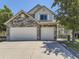 Charming two-story home featuring a stone facade and a spacious three-car garage at 10904 Eagle Run Dr, Parker, CO 80138