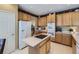 Bright kitchen with an island cooktop, oak cabinets, and modern appliances at 10904 Eagle Run Dr, Parker, CO 80138