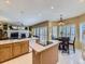 Bright eat-in kitchen featuring an island cooktop, tile floors, and an adjacent dining area at 10904 Eagle Run Dr, Parker, CO 80138