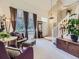 Bright, open living room with high ceilings, large windows, and elegant decor, including a staircase and chandelier at 10904 Eagle Run Dr, Parker, CO 80138