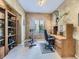 Cozy office space features a large window, neutral carpeting and walls, and built-in wooden desk at 10904 Eagle Run Dr, Parker, CO 80138