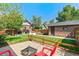 Lush backyard with a fire pit area, well-manicured lawn, and a view of the charming house and garden shed at 2740 N Fillmore St, Denver, CO 80205