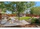 Serene backyard featuring a hammock, lush greenery, patio, and garden shed for outdoor relaxation and enjoyment at 2740 N Fillmore St, Denver, CO 80205