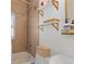 Updated bathroom with a shower/tub combo, tile surround, and stylish shelves at 2740 N Fillmore St, Denver, CO 80205