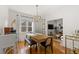 Bright dining room features a wood table, bench, and chairs, hardwood floors, and a view into the living room at 2740 N Fillmore St, Denver, CO 80205