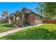Charming brick home featuring a well-manicured lawn and inviting front porch at 2740 N Fillmore St, Denver, CO 80205