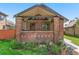 Inviting brick front porch with hanging plants and cozy seating at 2740 N Fillmore St, Denver, CO 80205