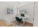 Home office features wood desk, green chair, built-in shelving and hardwood floors at 2740 N Fillmore St, Denver, CO 80205