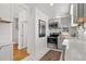 Modern kitchen with white cabinets, stainless steel appliances, and stylish backsplash at 2740 N Fillmore St, Denver, CO 80205