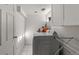 Well-lit laundry room features white tiled floors, ample cabinet space, and modern washer and dryer at 2740 N Fillmore St, Denver, CO 80205