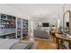 Bright living room featuring hardwood floors, built-in shelving, and comfortable seating at 2740 N Fillmore St, Denver, CO 80205