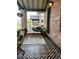 Charming screened-in porch with patterned floors and cozy seating arrangement at 2740 N Fillmore St, Denver, CO 80205
