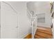 Stairwell with hardwood floors and white walls, leading to the upper level at 2740 N Fillmore St, Denver, CO 80205