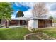 Expansive backyard featuring a patio, storage unit, and lush green lawn, ideal for relaxation and outdoor entertainment at 5582 E Colorado Ave, Denver, CO 80222