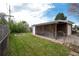 Spacious backyard with lush lawn, utility storage, and detached garage, perfect for outdoor activities and storage at 5582 E Colorado Ave, Denver, CO 80222