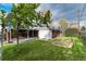 Large, green backyard showing both patio and utility storage space with fence on the right at 5582 E Colorado Ave, Denver, CO 80222