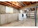 Unfinished basement with a washer and dryer hookups, offering potential for customization and storage at 5582 E Colorado Ave, Denver, CO 80222