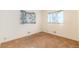 This bedroom has carpeted floors and two windows that allow for natural light to enter at 5582 E Colorado Ave, Denver, CO 80222
