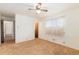 A bedroom featuring neutral carpet, a ceiling fan, closet, and a window at 5582 E Colorado Ave, Denver, CO 80222