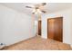 Bedroom featuring neutral carpet, a ceiling fan, closet, and a door leading to the hallway at 5582 E Colorado Ave, Denver, CO 80222