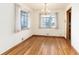 Bright dining room featuring hardwood floors, chandelier, and multiple windows for natural light at 5582 E Colorado Ave, Denver, CO 80222