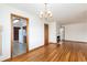 Open dining area with hardwood floors, chandelier, and easy access to the kitchen at 5582 E Colorado Ave, Denver, CO 80222