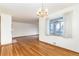 Dining room with hardwood floors, classic chandelier, and ample sunlight at 5582 E Colorado Ave, Denver, CO 80222