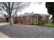 Brick home with a gravel front yard and mature landscaping, offering curb appeal at 5582 E Colorado Ave, Denver, CO 80222