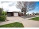 Brick home featuring a carport and garage, surrounded by a well-maintained yard at 5582 E Colorado Ave, Denver, CO 80222