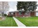 Charming brick home with a well-manicured front lawn and inviting walkway at 5582 E Colorado Ave, Denver, CO 80222