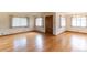 Bright living room featuring gleaming hardwood floors and natural light from multiple windows at 5582 E Colorado Ave, Denver, CO 80222