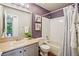 Bathroom with purple walls and a shower over tub combo at 1310 S Monaco Pkwy # 23, Denver, CO 80224