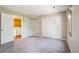 Carpeted bedroom with closet and laundry room access at 1310 S Monaco Pkwy # 23, Denver, CO 80224